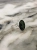 Close-up of an oval nephrite stone measuring 14 × 10 mm set in a delicate sterling silver band.