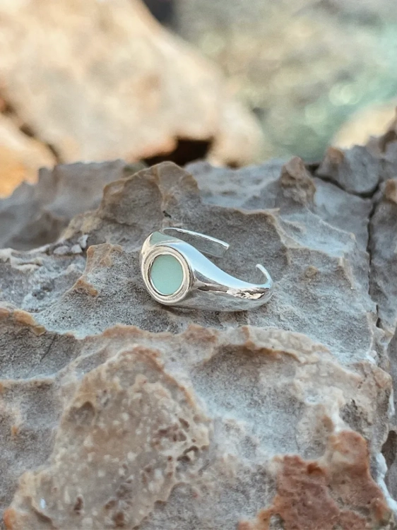 Close-up of natural chrysoprase set in a silver signet ring.