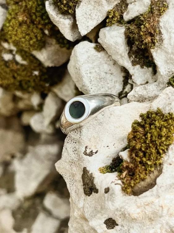 Close-up of elegant silver ring with natural dark nephrite.