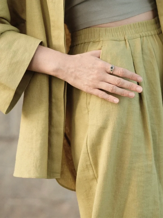 Silver signet ring with nephrite styled on a model’s hand.