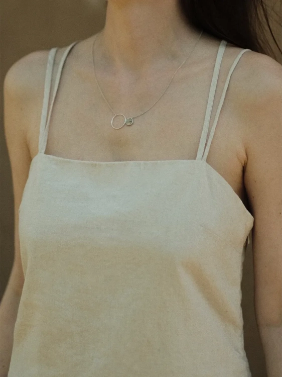 Silver necklace with dendrite stone worn by a woman – minimalist natural stone jewellery by Kamena.