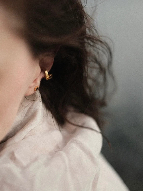 Delicate amber ear cuff styled as a modern jewelry accent