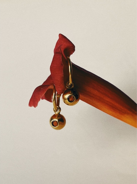 Gold-plated hoop earrings with Baltic amber set inside spheres
