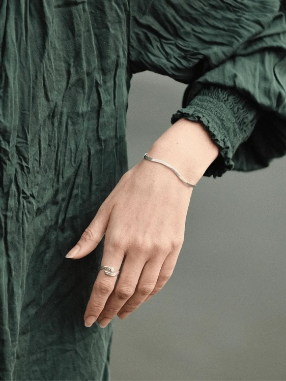 Sterling silver wave bracelet worn on the wrist