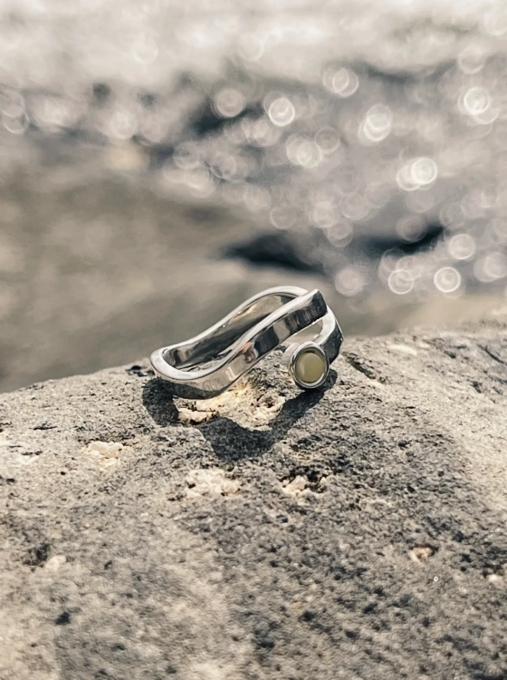 Wave-inspired sterling silver ring with amber, close-up detail