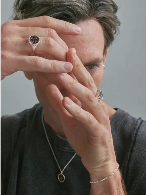 Men’s meteorite signet ring worn on the hand