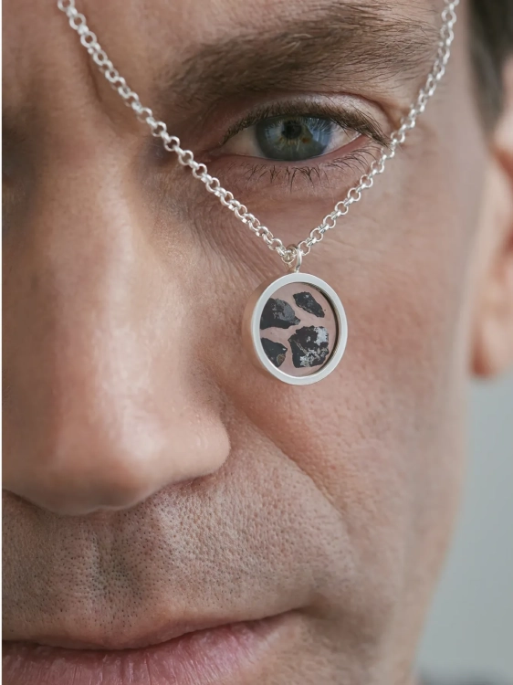 Men’s meteorite pendant necklace worn close to the face