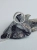 Close-up of a sterling silver pendant with iron meteorite fragments set in resin
