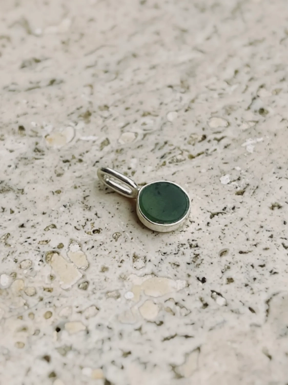 Small sterling silver pendant with natural green nephrite stone