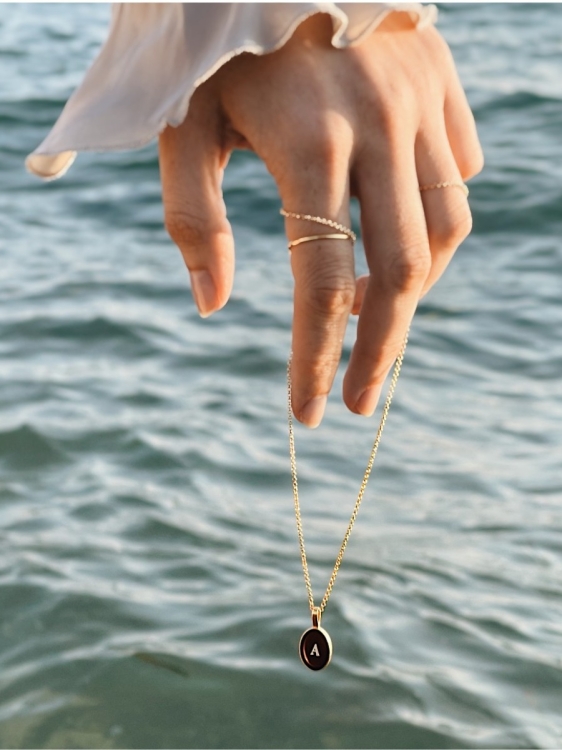 Gold-plated amber necklace with engraved initial as a meaningful gift