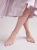 Gold-plated ankle bracelet worn on the leg in a summer style
