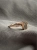 Minimal rose gold ring with natural meteorite, featuring a rectangular stone and a delicate band.