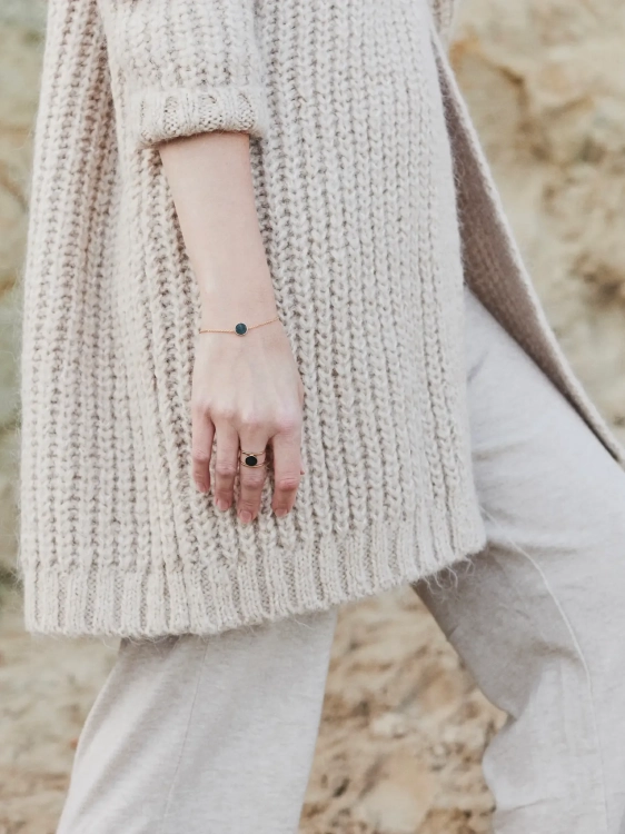 Delicate gold bracelet with Polish nephrite worn on wrist