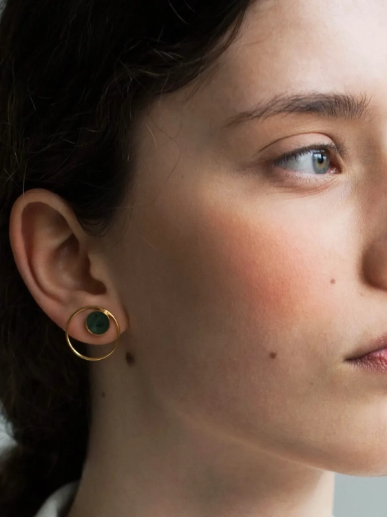 Gold hoop earrings with natural green nephrite stone worn by model – elegant minimalist jewelry