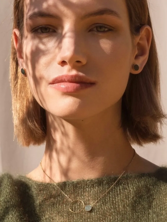 Elegant gold stud earrings with green gemstone accent