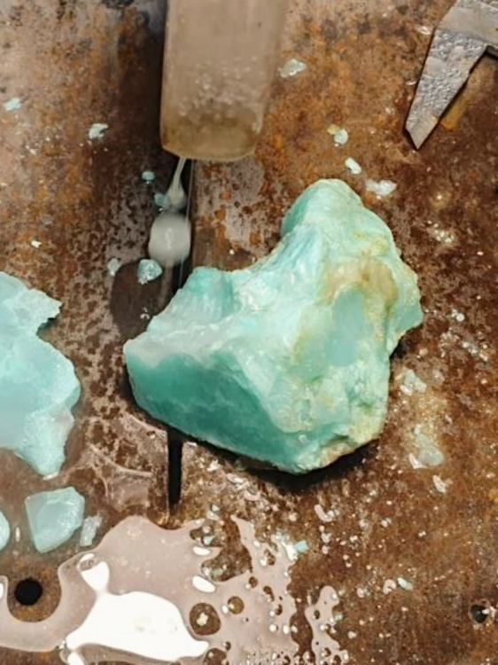 Raw chrysoprase from Poland being cut on diamond saw