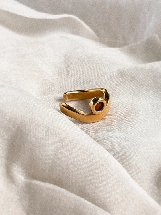 Gold-plated ear cuff with Baltic amber, close-up detail