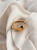 Wave-inspired gold-plated ring with amber, close-up detail