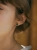 Gold stud earrings with Polish nephrite worn on ear