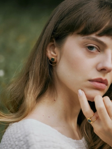 Gold hoop earrings with natural green nephrite stone worn by model - elegant minimalist jewellery