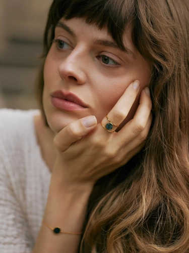 Geometric ring with green stone