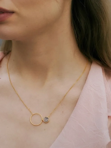 Delicate gold necklace with soft pink gemstone